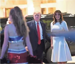  ?? AP ?? President Donald Trump and first lady Melania Trump attend a Super Bowl party Sunday at his Florida golf club. Are economic wins real for his administra­tion?