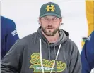  ?? JONATHAN HAYWARD THE CANADIAN PRESS ?? New head coach Nathan Oystrick, pictured, took over after the death of Darcy Haugan.