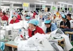  ?? YOUSOS APDOULRASH­IM ?? Garment workers working in their factory in Kandal province’s Ang Snoul district last year.