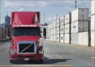  ?? THE CANADIAN PRESS FILE PHOTO ?? A truck moves through the Container Terminal in Halifax. Canada’s unemployme­nt rate fell to its lowest level in more than 40 years in December.