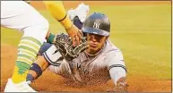  ?? Santiago Mejia / The San Francisco Chronicle ?? The New York Yankees’ Oswaldo Cabrera is caught stealing and is tagged out by Oakland Athletics third baseman Vimael Machin in the sixth inning on Aug. 27 at RingCentra­l Coliseum in Oakland, Calif.