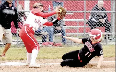  ?? PHOTO BY RICK PECK ?? McDonald County’s Kylie Helm slides into third base with a triple before Ozark third baseman Tara McCormack can get a tag on her during the Lady Tigers 5-2 win on Oct. 13 at MCHS in a Missouri Class 4 sectional softball playoff game.