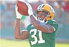  ?? JIM MATTHEWS / USA TODAY NETWORK-WISCONSIN ?? Packers cornerback Davon House catches a ball during training camp at Ray Nitschke Field.