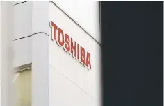  ??  ?? The logo of Toshiba Corp is seen at a building in Tokyo. Japan has enlisted electronic­s firm Toshiba Corp to help it try to win Asia’s biggest defense contract, a A$50 billion (US$36 billion) deal to build a dozen submarines for Australia, three...