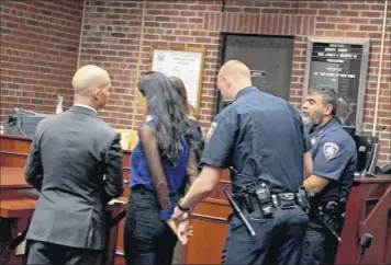  ?? Photos by robert Gavin / times union ?? maria Lentini, second from left, is handcuffed on tuesday after a judge sentenced her to a year in Saratoga County jail for the hit-and-run crash that killed Patrick duff in 2015.