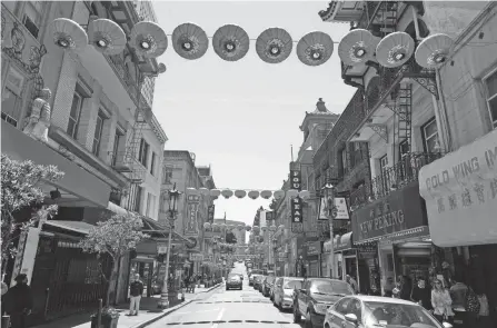  ?? PHOTOS BY ERIC RISBERG/AP ?? Lanterns hang in Chinatown above Grant Avenue in San Francisco.