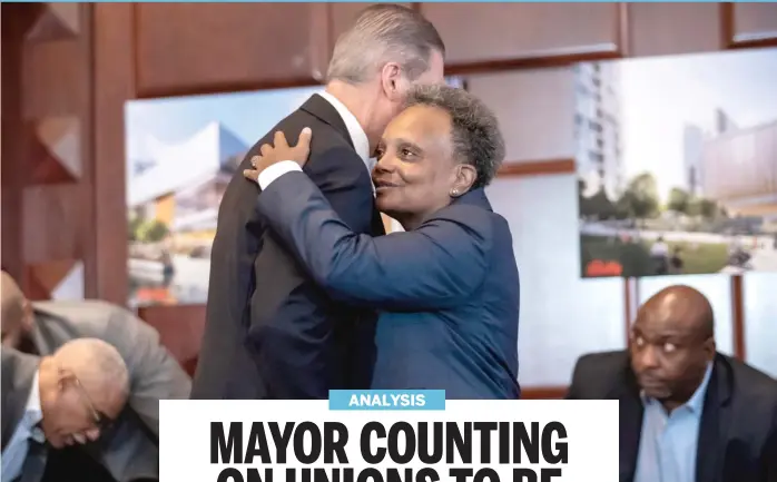 ?? ASHLEE REZIN/SUN-TIMES ?? Mayor Lori Lightfoot hugs Gary Perinar, of the Mid-America Carpenters Regional Council, after announcing Bally’s as her pick to run Chicago’s casino at the site of the Chicago Tribune’s printing plant in River West.