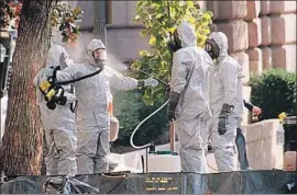  ?? Ron Thomas Associated Press ?? HAZMAT workers clean up on Capitol Hill in October 2001. They were responding to anthrax-laced letters, part of the worst biological attack in U.S. history.