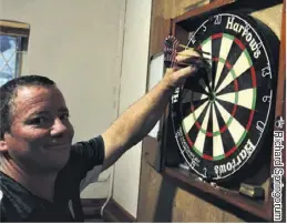  ??  ?? Hans Stander collects his darts during the warm-ups