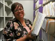  ?? ZACH SRNIS — THE MORNING JOURNAL ?? Lorain City Treasurer Terri Soto holds up tax documents filed at her office.