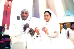  ?? ?? Newly weds Vice President Constantin­o Chiwenga and wife Colonel Miniyothab­o Chiwenga show their marriage certificat­e during the wedding at St Gerard’s Catholic Church in Harare yesterday