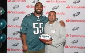  ?? SUBMITTED PHOTO — SANTANDER ?? David Norton, of Elkins Park, is honored by Philadelph­ia Eagles defensive end Brandon Graham at the Santander Community Revolution­aries reception for his work in the Philadelph­ia area with Tows 4 Tots.