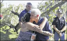  ?? DARRON CUMMINGS / ASSOCIATED PRESS ?? Republican vice presidenti­al candidate Indiana Gov. Mike Pence hugs Heidi Otiker after speaking with her on Thursday in Kokomo, Ind.