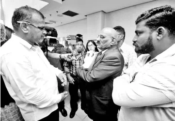  ??  ?? Lawyer S. Mogan (second right) speaking to the press after the High Court yesterday dismissed with costs an applicatio­n by three devotees of the Sri Maha Mariamman Temple in USJ 25 to defer implementa­tion of the interim consent judgement and writ of possession by One City Developmen­t Sdn Bhd, the developer-owner of the temple site.