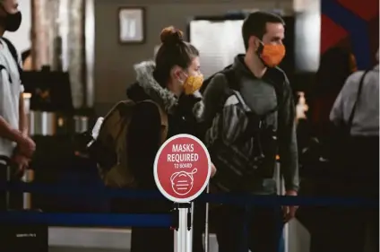 ?? David Zalubowski / Associated Press ?? Masks are a requiremen­t at U.S. airports, but most domestic airline passengers do not need to be vaccinated.
