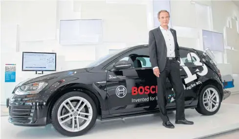  ?? AFP ?? In this photo taken on April 25, 2018, Volkmar Denner, CEO of Robert Bosch GmbH, poses next to a diesel powered test car prior to the company’s annual press conference at the Bosch Technology Center in Renningen, southweste­rn Germany.