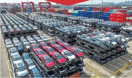  ?? Picture: AFP VIA GETTY ?? Global drive: Electric cars are stacked high before being shipped from Suzhou in China