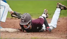  ?? DANA JENSEN/THE DAY ?? East Lyme’s John Bureau dives safely back to first base on the pickoff attempt during Saturday’s game at Waterford.
