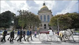  ?? HYOSUB SHIN/AJC 2020 ?? A horse drawn carriage transports the casket of the Rev. C.T. Vivian from the state Capitol to the King Center on July 22, 2020. Vivian, a legendary civil rights icon, died at 95 on the morning of July 17 at his home in Atlanta.