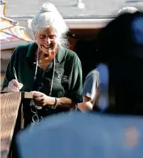  ?? ?? Chris Plauche registers clients on July 2 for a town hall meeting about her brainchild: Towne Twin Village.