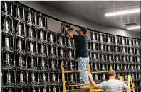  ?? AP/WAYNE PARRY ?? In this photo taken earlier this month, workers prepare to install gigantic video screens at Resorts Casino in Atlantic City N.J. The casino’s new sports betting facility, co-operated with DraftKings, will open this week.