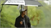  ?? TIM NWACHUKWU — GETTY IMAGES ?? Chico’s Kurt Kitayama looks on from under an umbrella after hitting his shot from the eighth tee during the second round of the Wells Fargo Championsh­ip at TPC Potomac Clubhouse on Friday in Potomac, Md.