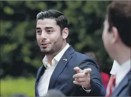  ??  ?? TWO CANDIDATES to replace Hunter in Congress, Democrat Ammar CampaNajja­r, left, and Republican Carl DeMaio, spoke outside the courthouse last week.