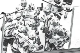  ?? GETTY IMAGES ?? Lightning teammates mob Kevin Shattenkir­k (22) after he scored the gamewinnin­g goal in overtime in Game 4 of the Stanley Cup Final Friday.