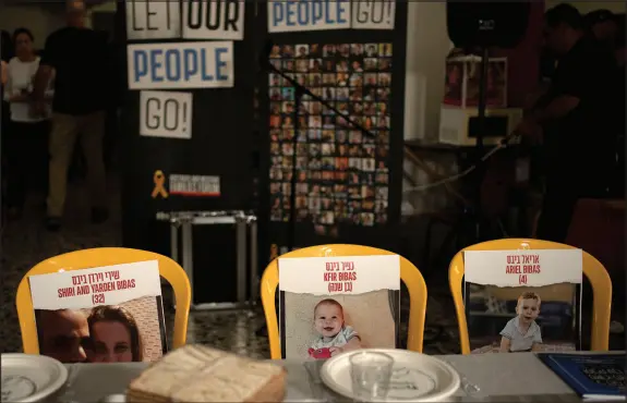  ?? PHOTOS BY MAYA ALLERUZZO / ASSOCIATED PRESS ?? Chairs are set April 11 for missing members of the Bibas family who are held hostage in Gaza, at the communal dining hall at Kibbutz Nir Oz in southern Israel — where a quarter of all residents were killed or captured by Hamas on Oct. 7.