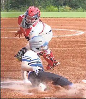  ?? Scott Herpst ?? Ringgold’s Piper Gilbert slides into home safely, just ahead of an attempted tag by Saddle Ridge catcher Tamra Yancy, during last week’s contest in Rock Spring.