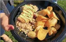  ?? JANET PODOLAK — THE NEWS-HERALD ?? A swordfish fillet napped with lemon-chive aioli and served over red beans and rice with homemade potato chips was the most requested entree at the Arboretum’s gypsy jazz concert.