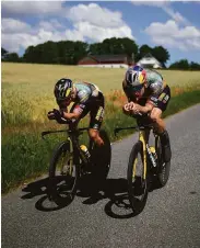  ?? Daniel Cole / Associated Press ?? Slovenia’s Primoz Roglic (left) and Belgium’s Wout van Aert train near Copenhagen, Denmark.