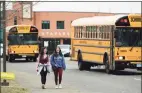  ?? Erik Trautmann / Hearst Connecticu­t Media file photo ?? Students leave Staples High School on the announceme­nt that Westport Schools will be closed for the foreseeabl­e future on March 11, 2020, in response to the COVID-19 virus pandemic.