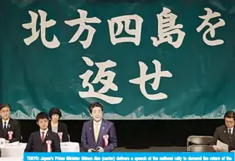  ??  ?? TOKYO: Japan’s Prime Minister Shinzo Abe (center) delivers a speech at the national rally to demand the return of the Northern Territorie­s, a group of islands held by Russia. —AFP
