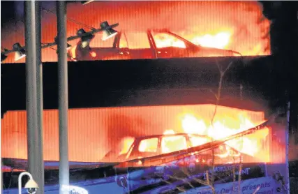  ?? Peter Byrne ?? > Vehicles burn during the blaze at a multi-storey car park at the Echo Arena on Liverpool’s waterfront