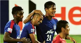  ?? — R. SAMUEL ?? Bengaluru FC’s Mandar Rao Desai celebrates his goal with team mates.