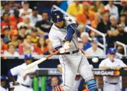  ?? THE ASSOCIATED PRESS ?? Houston Astros George Springer delivers a hit for the American League during the first inning at the MLB All-Star Game Tuesday in Miami.