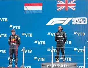  ?? REUTERS ?? Champion Lewis Hamilton, right, and runner-up Max Verstappen on the podium after the Russian Grand Prix.