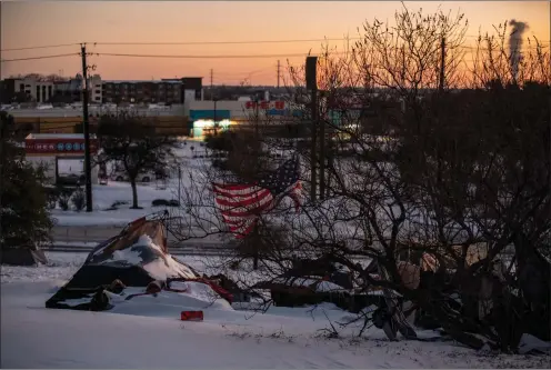  ?? Washington Post photo by Sergio Flores ?? A homeless camp in Austin last month, covered in a rare snow.