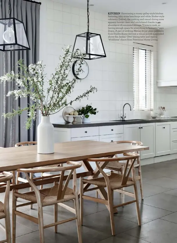  ??  ?? KITCHEN Showcasing a roomy galley-style kitchen featuring inky stone benchtops and white Shaker-style cabinetry (below), the cooking and casual dining zone appears forever clean and uncluttere­d thanks to an abundance of concealed storage. “I love to cook, so having enough space for everything is fantastic,” says Diana. A pair of striking Mercer Street glass pendants from Dunlin Home delivers a visual punch suspended above the Jardan ‘Otto’ dining table and replica ‘Wishbone’ chairs from Provincial Home Living.