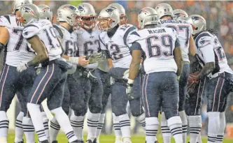  ?? RON CHENOY, USA TODAY SPORTS ?? Patriots quarterbac­k Tom Brady (12) should get back several of his top weapons on offense in the coming weeks.