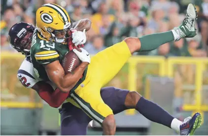  ?? MARK HOFFMAN / MILWAUKEE JOURNAL SENTINEL ?? Packers wide receiver Allen Lazard scores a touchdown on a 27-yard reception while being covered by Texans cornerback Lonnie Johnson on Thursday night at Lambeau Field.