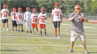  ?? JANE PHILLIPS/FOR THE NEW MEXICAN ?? New Mexico School for the Deaf coach James Litchfield III leads his team in a drill Thursday. The Roadrunner­s have 14 players for their six-man team.