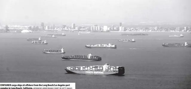  ?? MEDIANEWS GROUP/ORANGE COUNTY RE/GETTY IMAGES ?? CONTAINER cargo ships sit offshore from the Long Beach/los Angeles port complex in Long Beach, California.