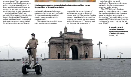  ?? Photos / AP ?? A security guard patrols a deserted square at the Gateway of India in Mumbai.