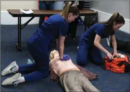  ?? The Sentinel-Record/Grace Brown ?? SKILLS AT WORK: Gravette High School students Austyn Russell, left, and Gabbi Scott participat­e in the CPR competitio­n during the Arkansas HOSA State Conference at the Hot Springs Convention Center on Thursday. Students from 35 different schools across...