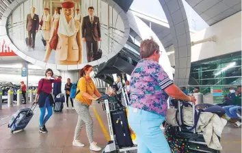  ?? Ahmed Ramzan/ Gulf News ?? Passengers at Dubai Internatio­nal Airport, Terminal 3. As more countries lift restrictio­ns imposed due to lockdowns, experts say, air fares will drop from their current highs.