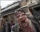  ?? PHOTO BY ED CRISOSTOMO, LOS ANGELES DAILY NEWS/SCNG ?? The walking dead act out a scene during a special sneak peek event of “The Walking Dead” permanent daytime attraction at Universal Studios Hollywood in Universal City, Calif.