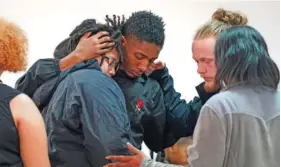 ?? AP PHOTO/SEAN RAYFORD ?? People comfort each other Wednesday at Word of God Ministries in Scranton, S.C., after a vigil for a group of Americans recently kidnapped in Mexico.
