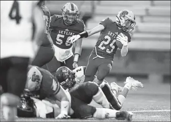  ?? Timothy Hurst / Staff Photograph­er ?? Skyline’s Grayden Bridwell tries to break a tackle Friday night against Silver Creek in Longmont.